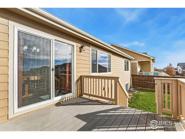 a view of a house with a yard and deck