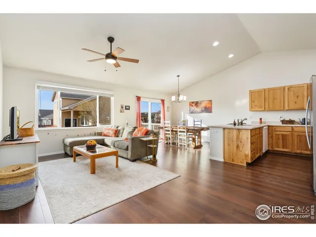 a living room with lots of furniture and kitchen view