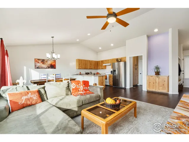 a living room with furniture and kitchen view