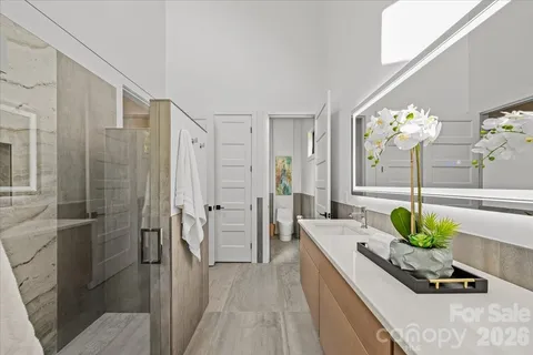 a room with stainless steel appliances kitchen island granite countertop furniture and shower