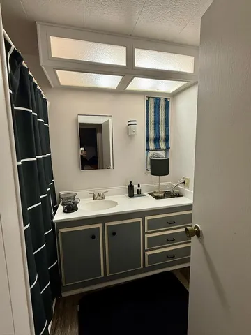 a bed sitting in a bedroom next to a bedroom