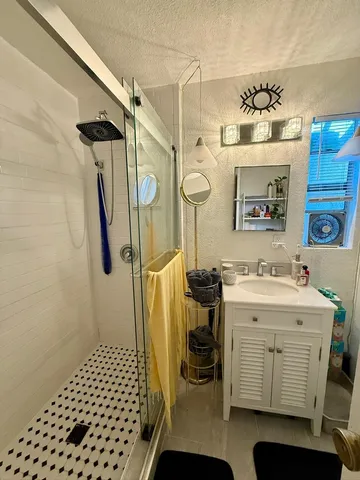 a living room with blue lights with furniture and floor to ceiling window