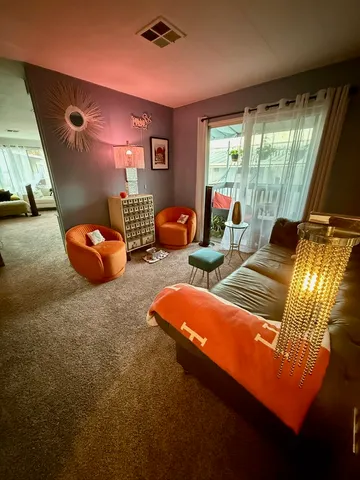 a living room with furniture a rug and a projector