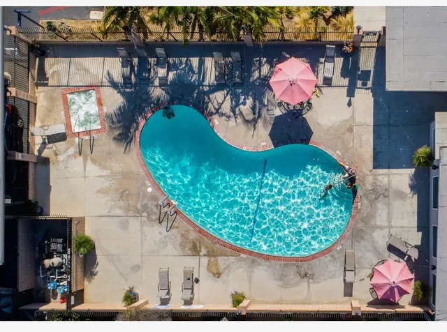 a view of a lake with a table chairs and a swimming pool