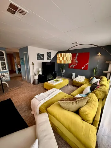 a living room with furniture and a chandelier