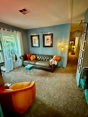 a living room with furniture rug and window