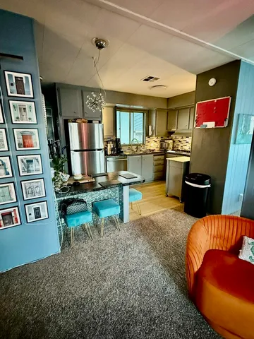 a view of a hallway with wooden floor and stairs