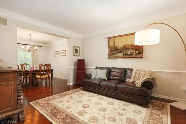 a living room with furniture and a dining table