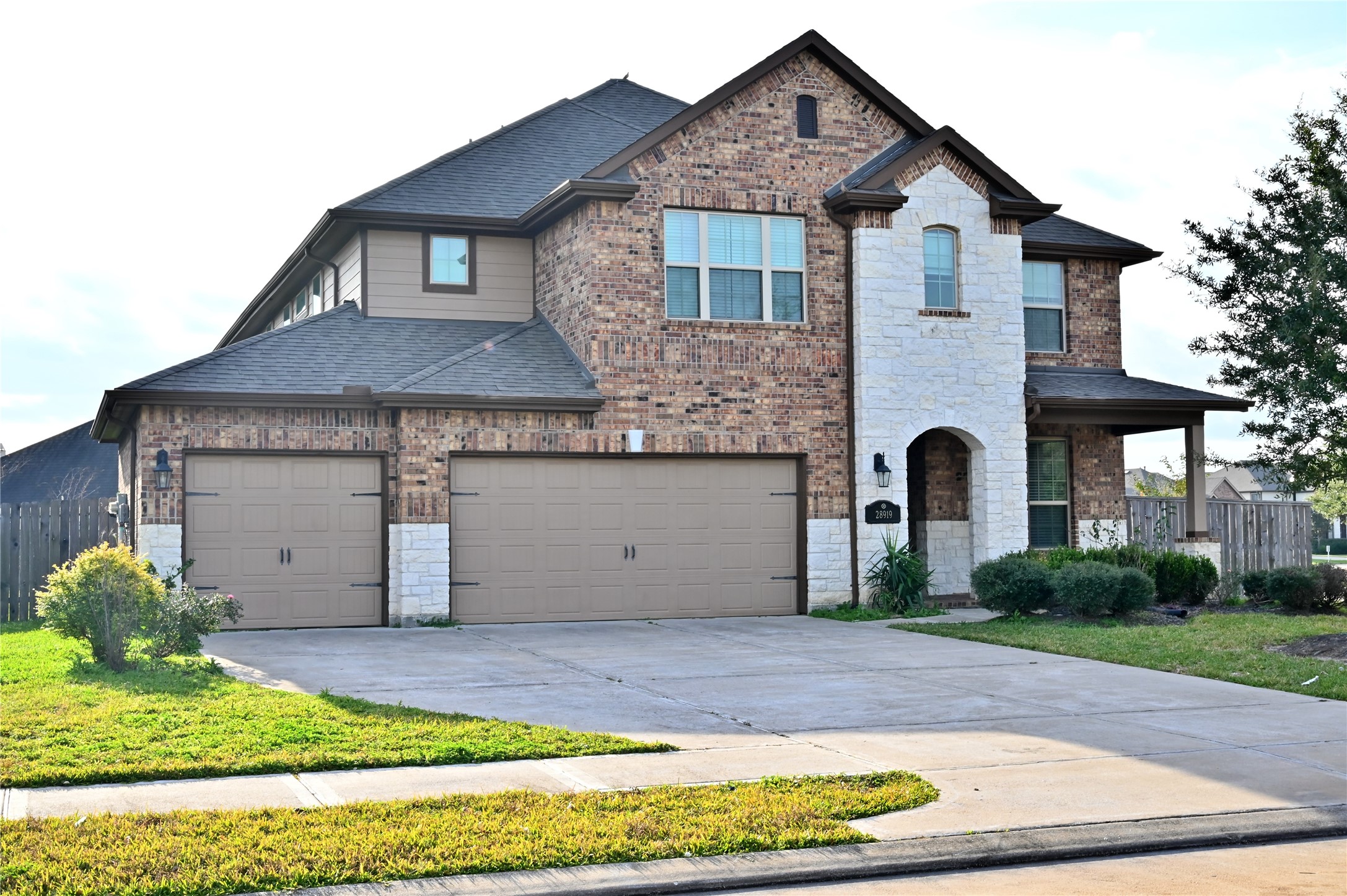 a front view of a house with a yard and garage