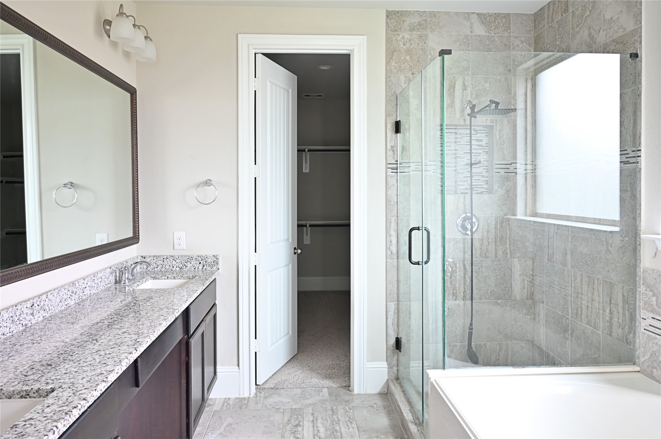 28919 Copper Break Court Katy, TX 77494 - Photo 17 of 31 a bathroom with a granite countertop tub shower and sink