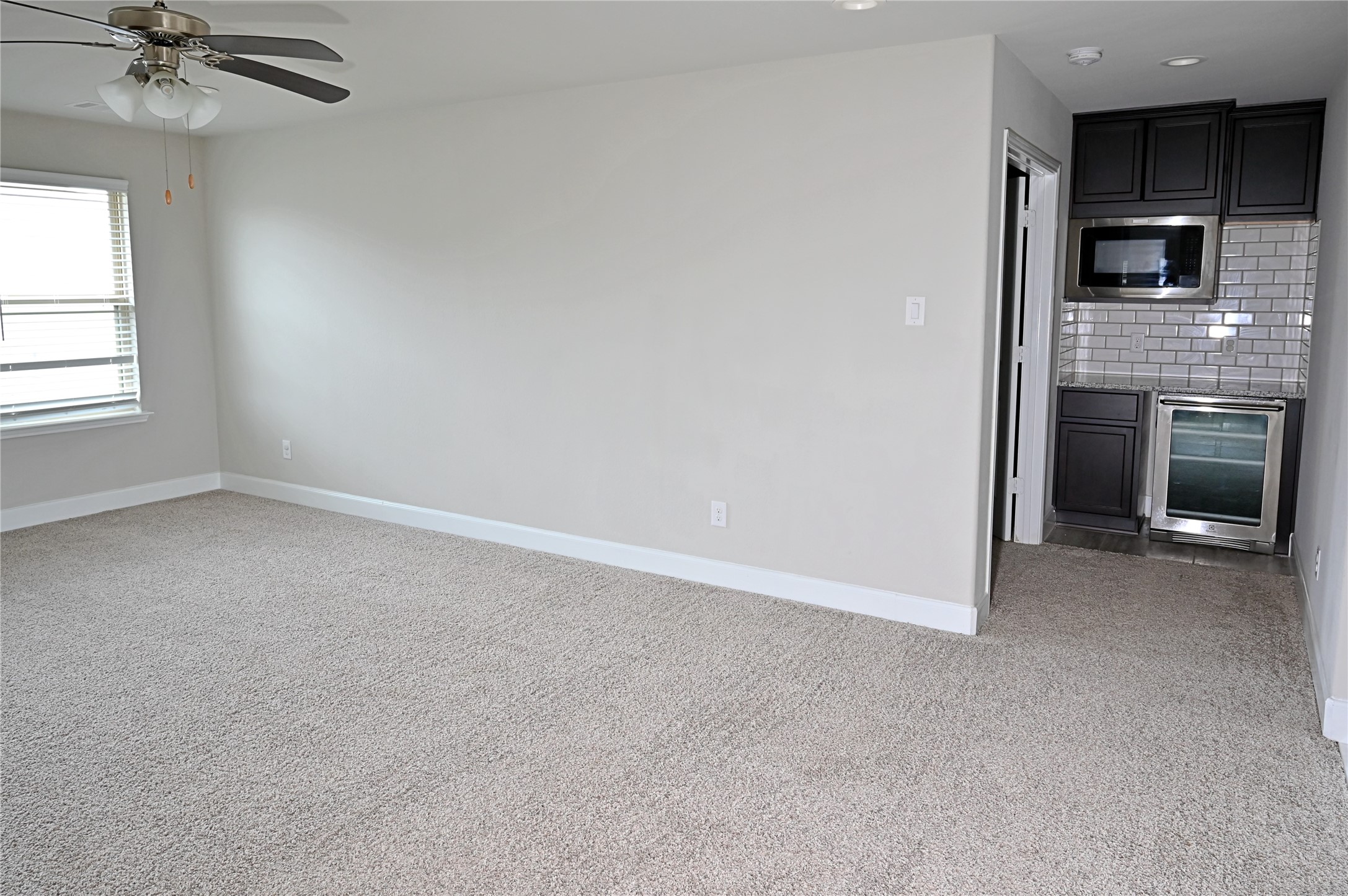 28919 Copper Break Court Katy, TX 77494 - Photo 27 of 31 an empty room with a fireplace and windows