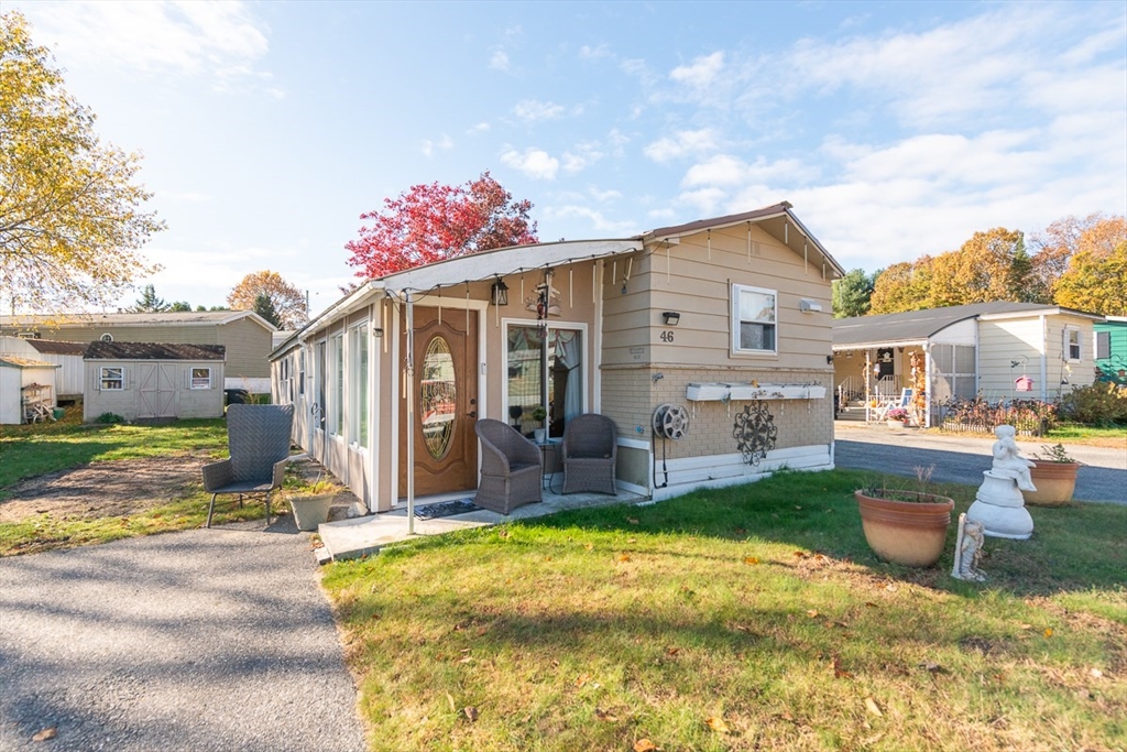 239 Ayer Road, Unit 46 Littleton, MA 01460 - Photo 1 of 28 a view of a house with backyard porch and sitting area