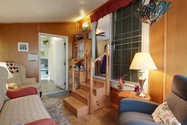 a living room with furniture and a lamp