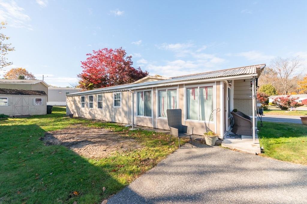 239 Ayer Road, Unit 46 Littleton, MA 01460 - Photo 24 of 28 a view of a house with backyard and sitting area