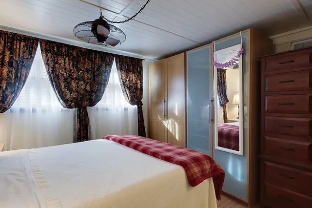 a bedroom with a bed and a walk in closet