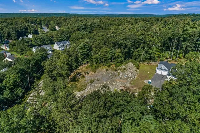 a view of a yard with wooden fence