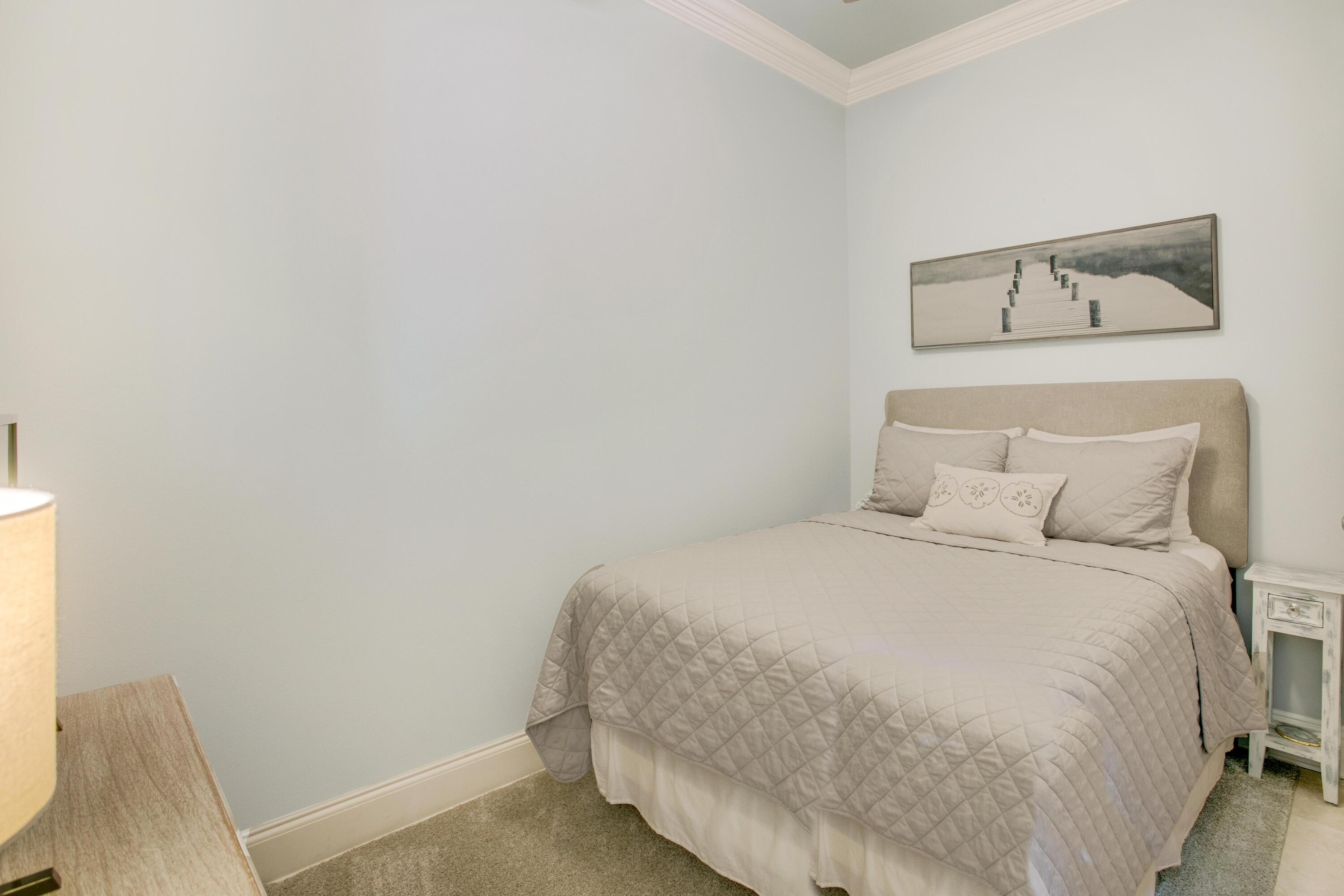 1893 Baytowne Loop Miramar Beach, FL 32550 - Photo 23 of 45 a bedroom with a bed and a chair