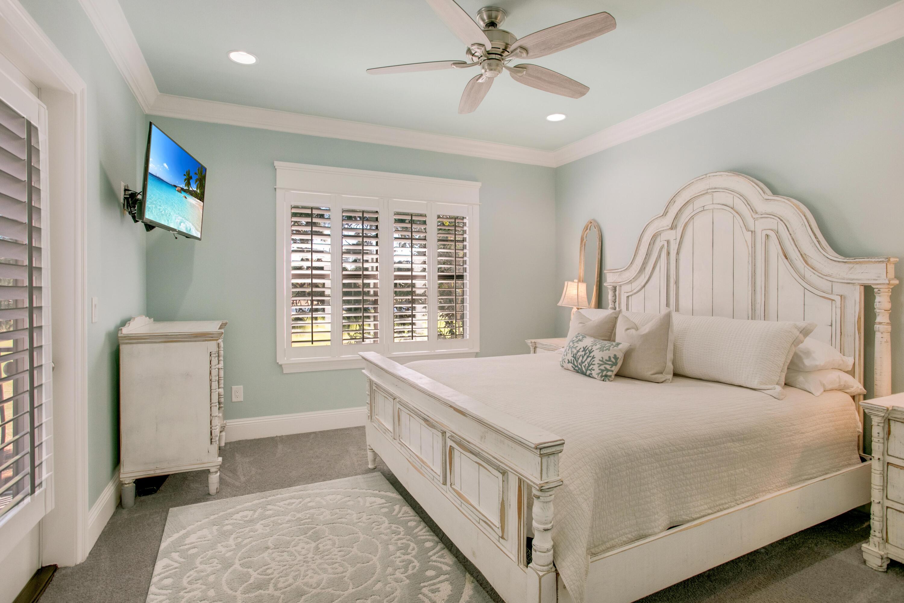 1893 Baytowne Loop Miramar Beach, FL 32550 - Photo 30 of 45 a bedroom with a bed a mirror and a chandelier