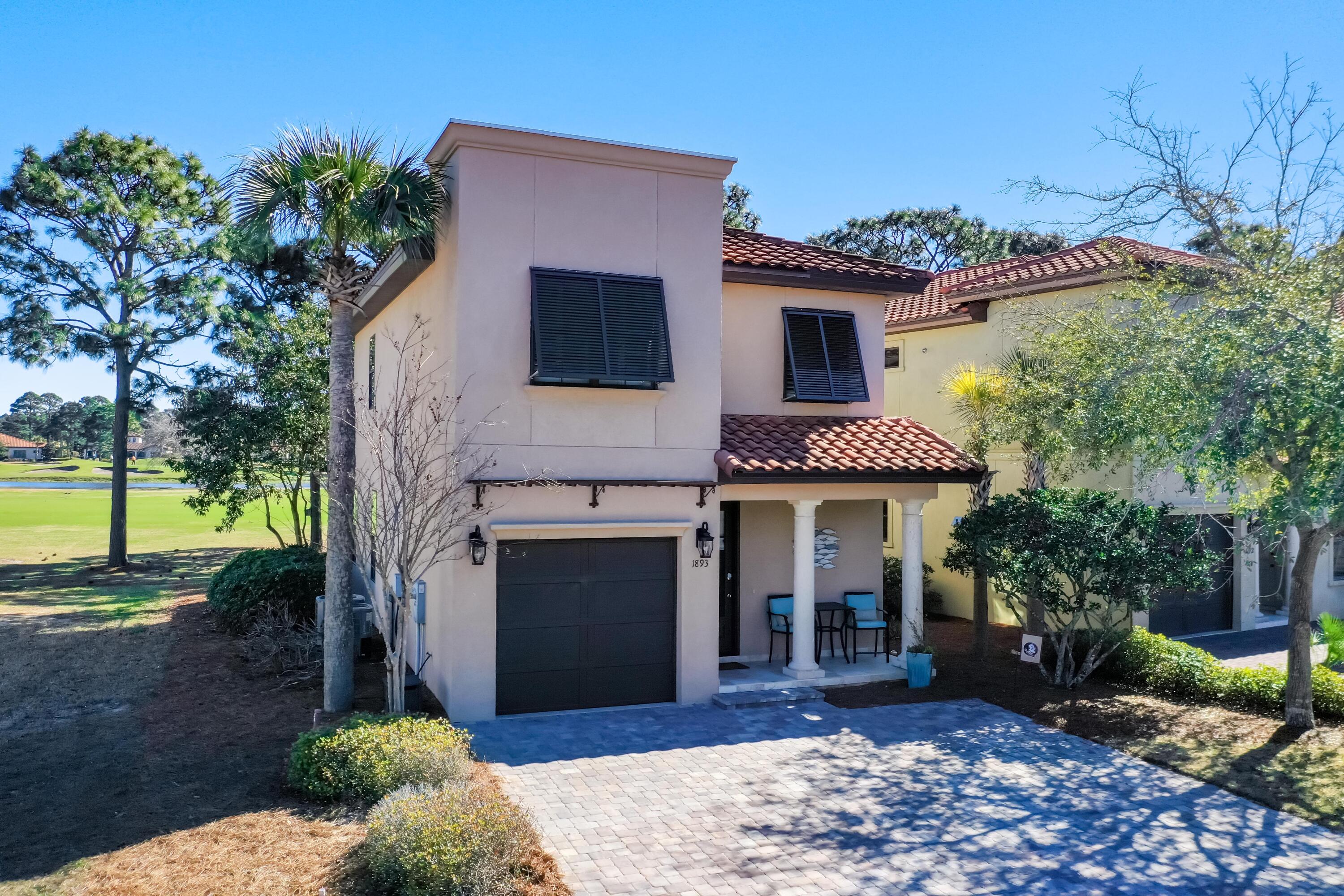 1893 Baytowne Loop Miramar Beach, FL 32550 - Photo 3 of 45 a front view of a house with a garden