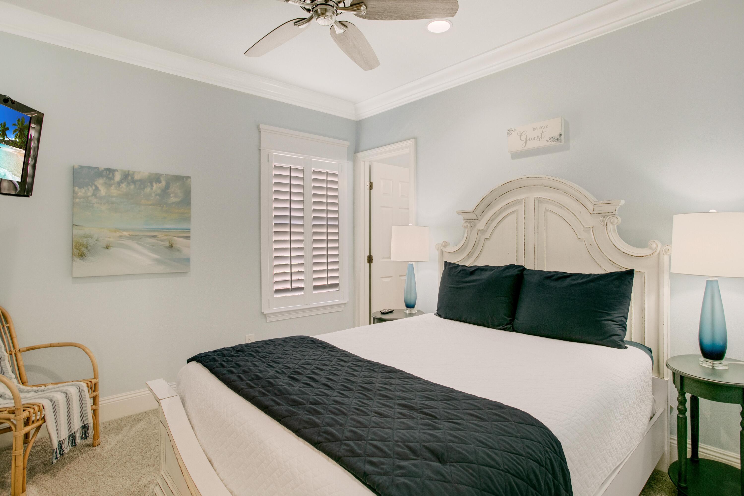 1893 Baytowne Loop Miramar Beach, FL 32550 - Photo 34 of 45 a bedroom with a bed and a chandelier