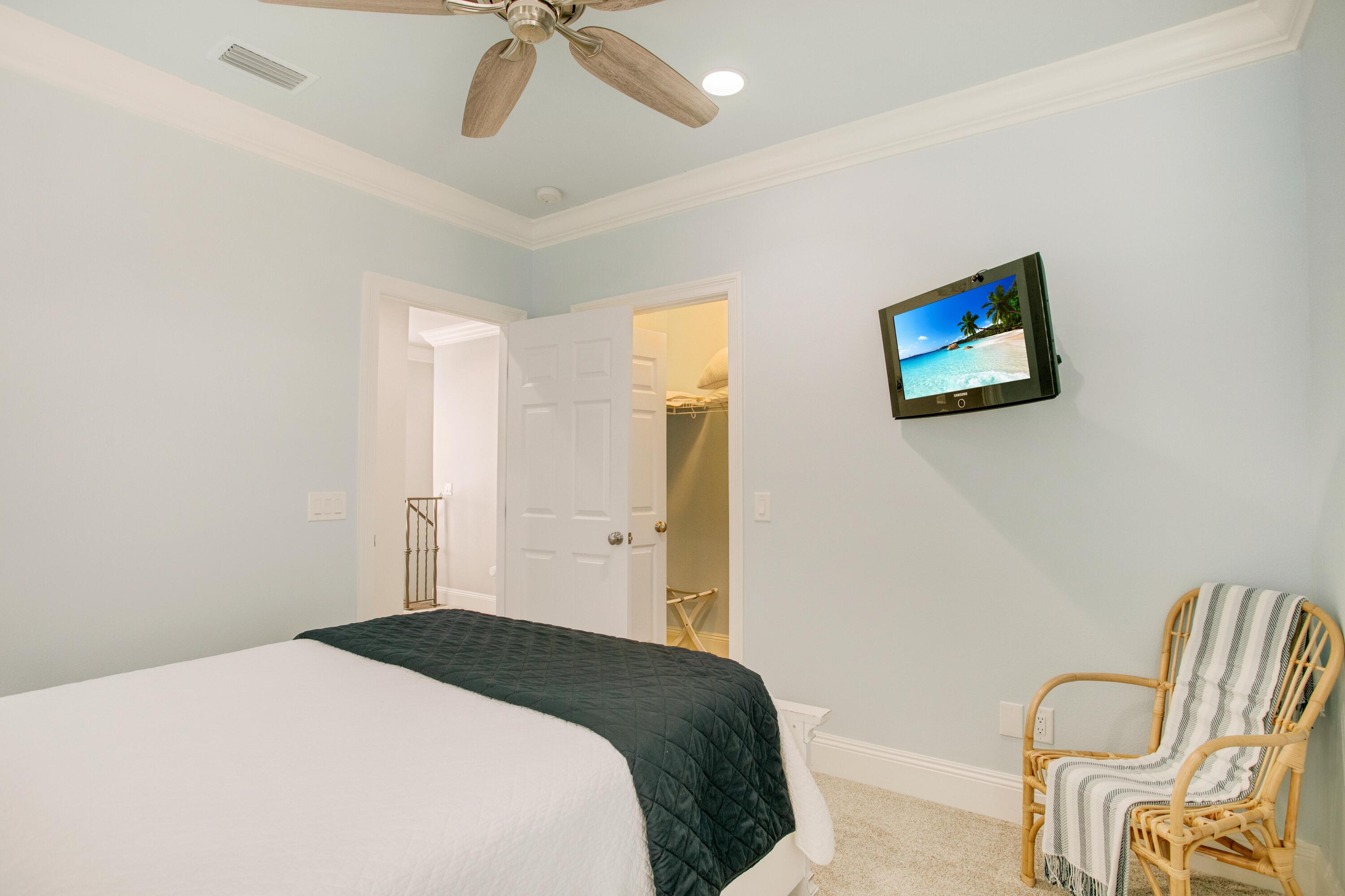 1893 Baytowne Loop Miramar Beach, FL 32550 - Photo 35 of 45 a bedroom with a bed and a chair