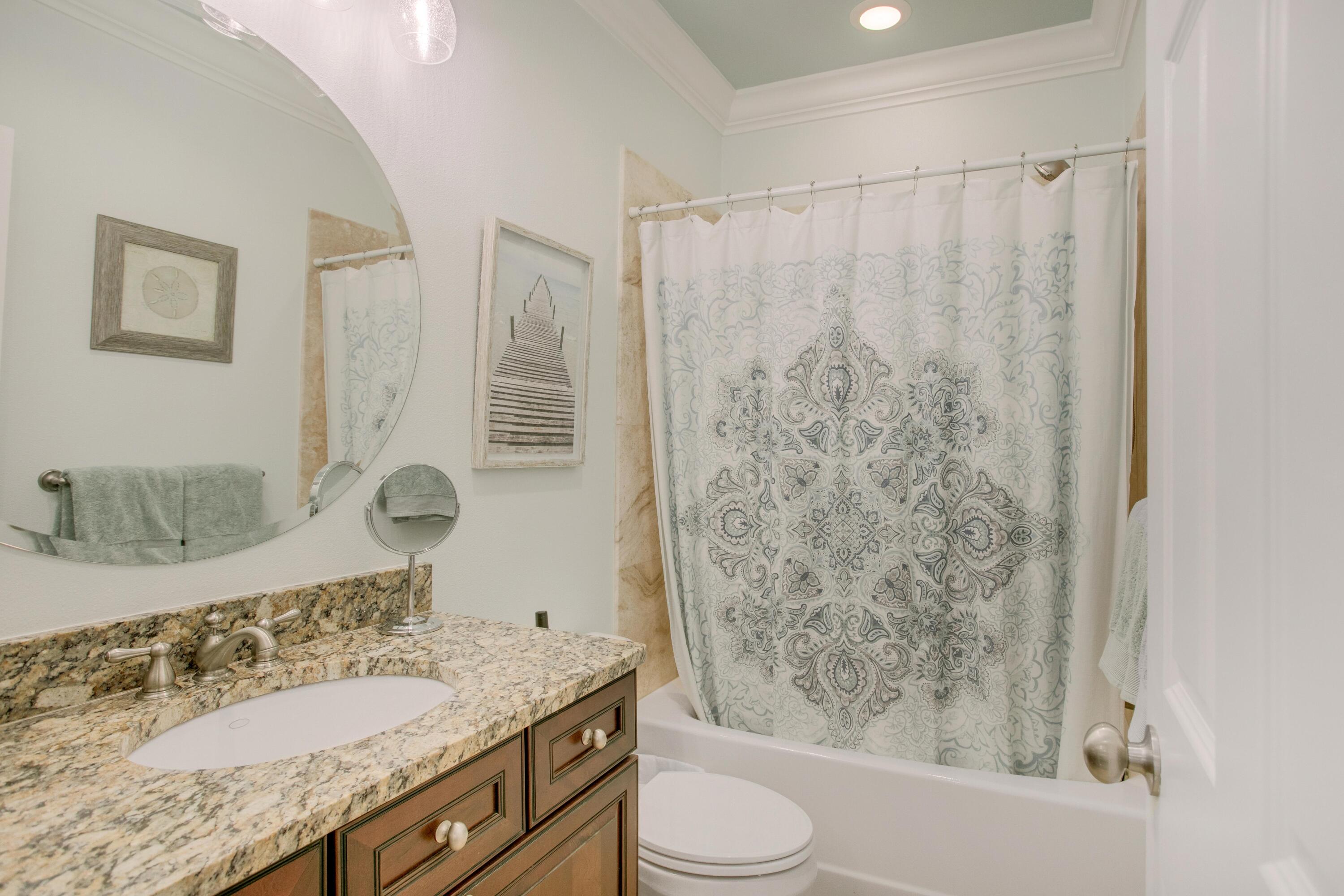 1893 Baytowne Loop Miramar Beach, FL 32550 - Photo 39 of 45 a bathroom with a granite countertop sink a toilet and shower