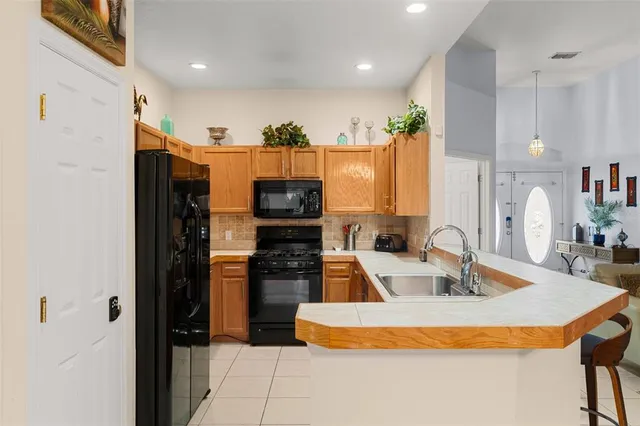 a kitchen with stainless steel appliances granite countertop a refrigerator and a stove