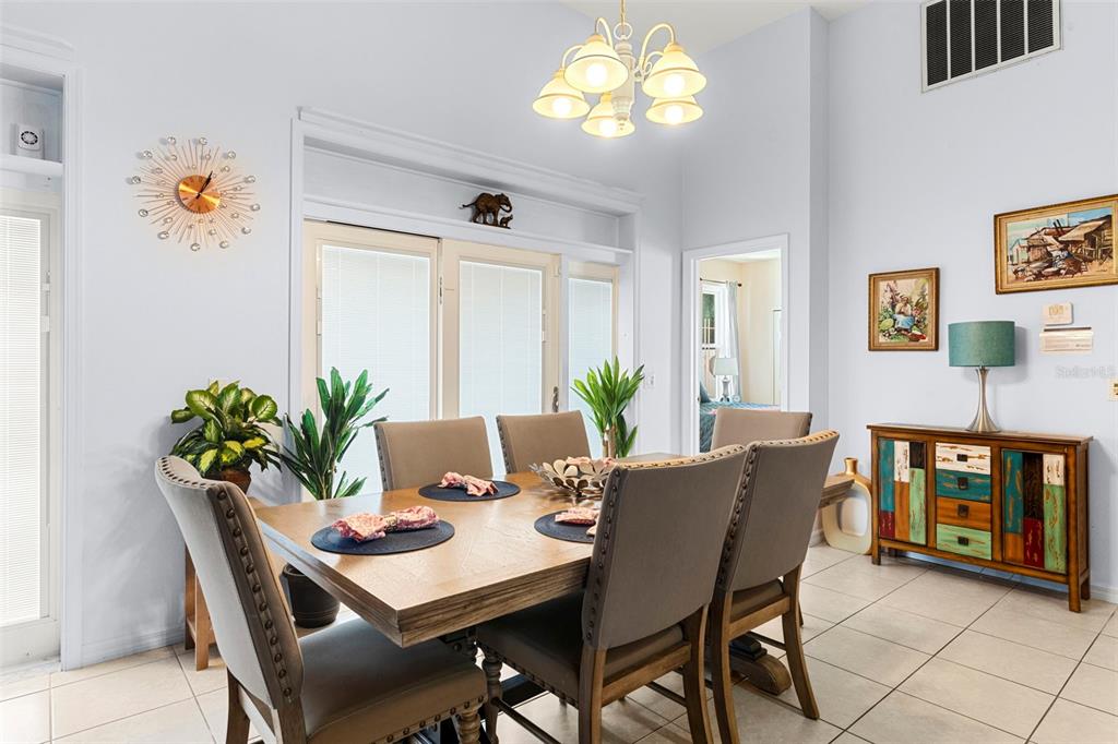 235 Hollinghead Loop Davenport, FL 33896 - Photo 12 of 30 a view of a dining room with furniture and chandelier