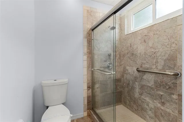 a bathroom with a toilet and shower
