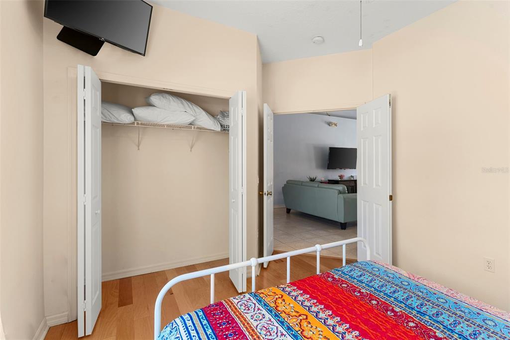 235 Hollinghead Loop Davenport, FL 33896 - Photo 20 of 30 a living room with a bed and furniture