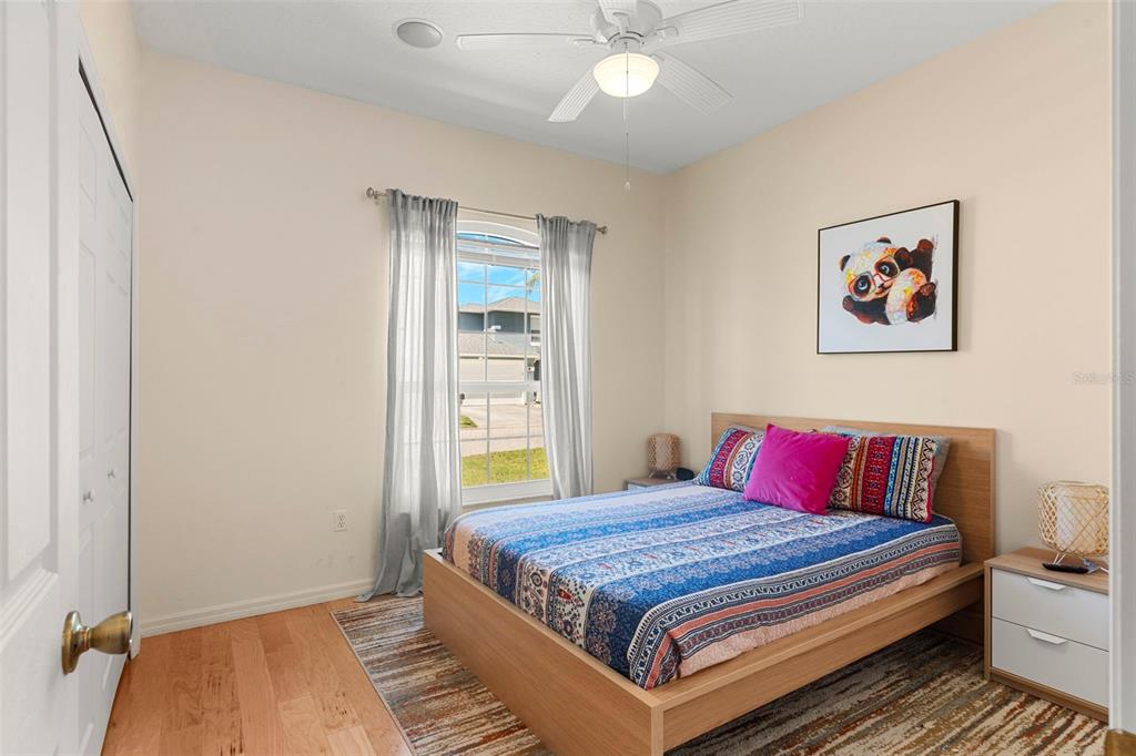 235 Hollinghead Loop Davenport, FL 33896 - Photo 21 of 30 a bedroom with a bed and a chandelier