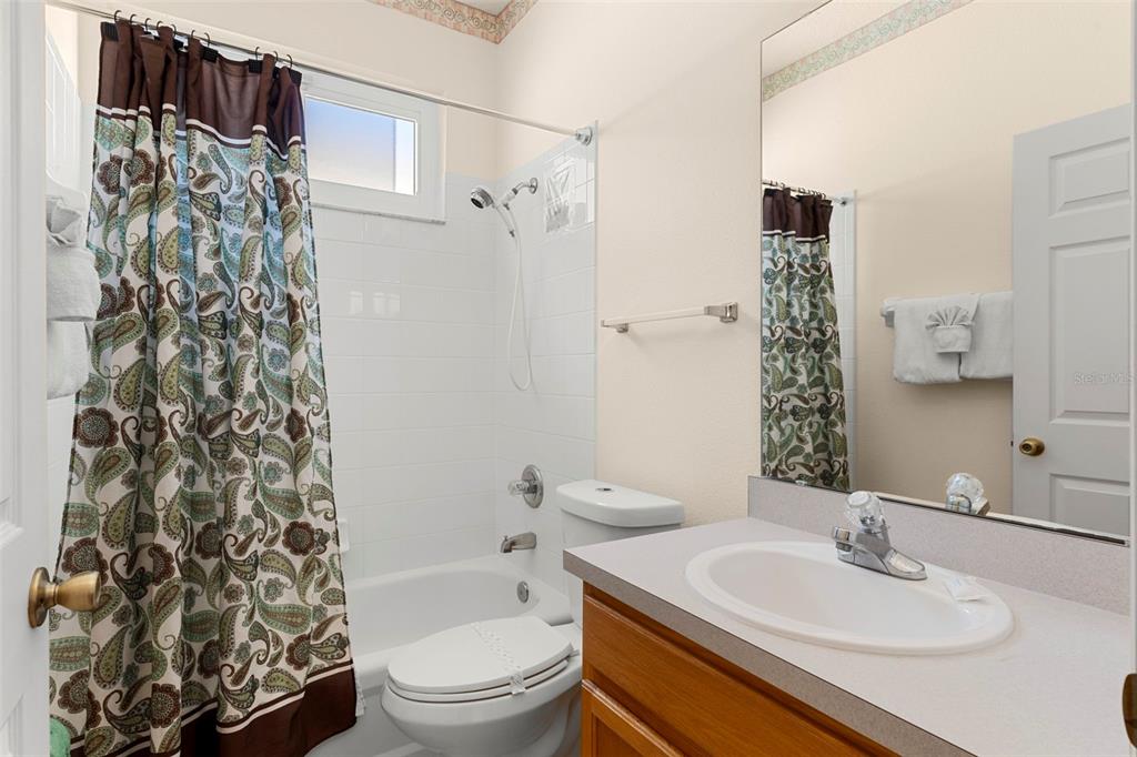 235 Hollinghead Loop Davenport, FL 33896 - Photo 23 of 30 a bathroom with a sink toilet and shower