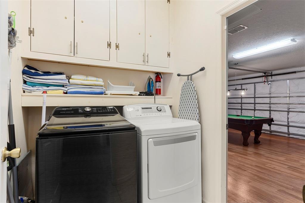 235 Hollinghead Loop Davenport, FL 33896 - Photo 25 of 30 a utility room with dryer and washer