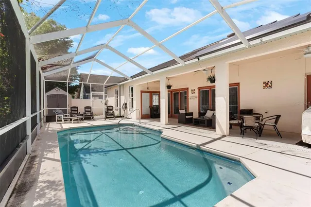 a view of a swimming pool with chairs