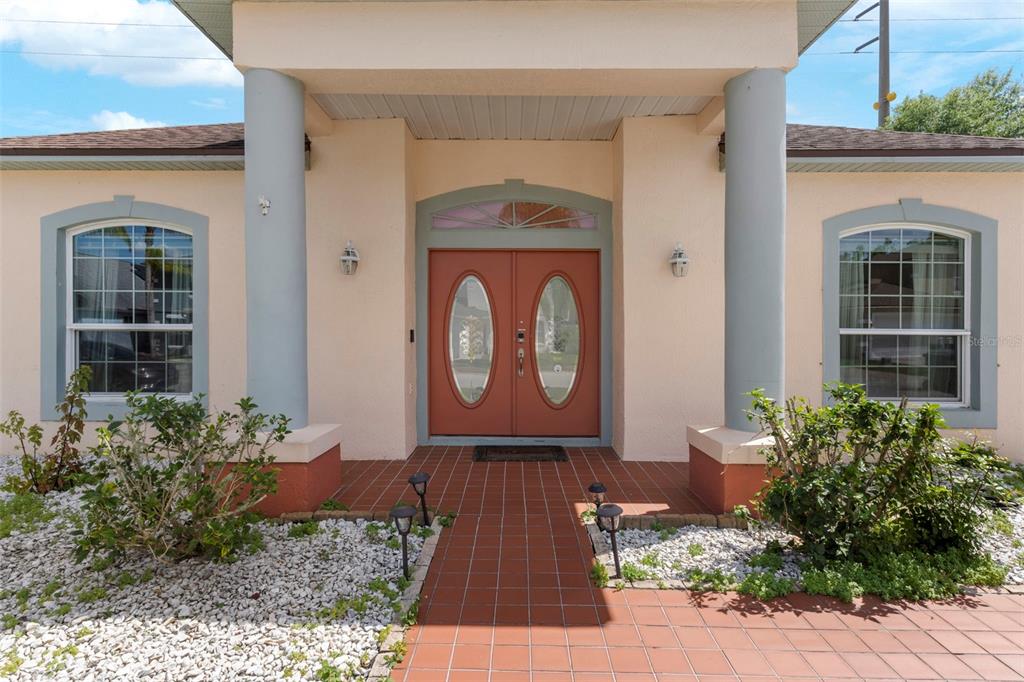 235 Hollinghead Loop Davenport, FL 33896 - Photo 3 of 30 a front view of a house with garden