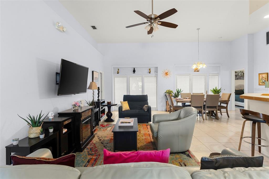 235 Hollinghead Loop Davenport, FL 33896 - Photo 5 of 30 a living room with furniture and a flat screen tv