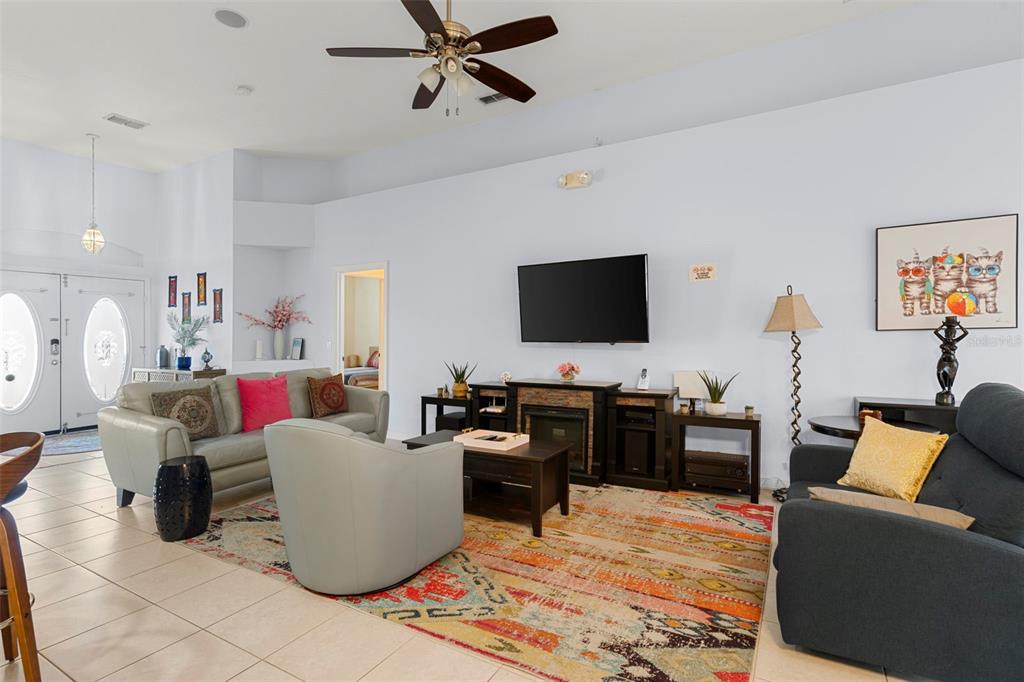235 Hollinghead Loop Davenport, FL 33896 - Photo 6 of 30 a living room with furniture and a flat screen tv