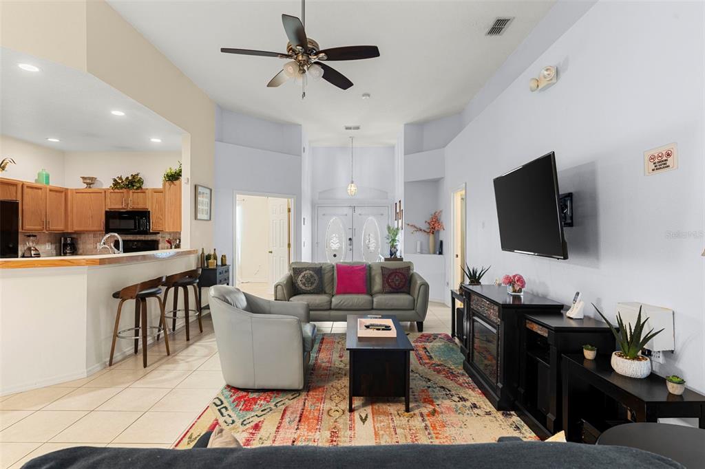 235 Hollinghead Loop Davenport, FL 33896 - Photo 7 of 30 a living room with furniture and a flat screen tv