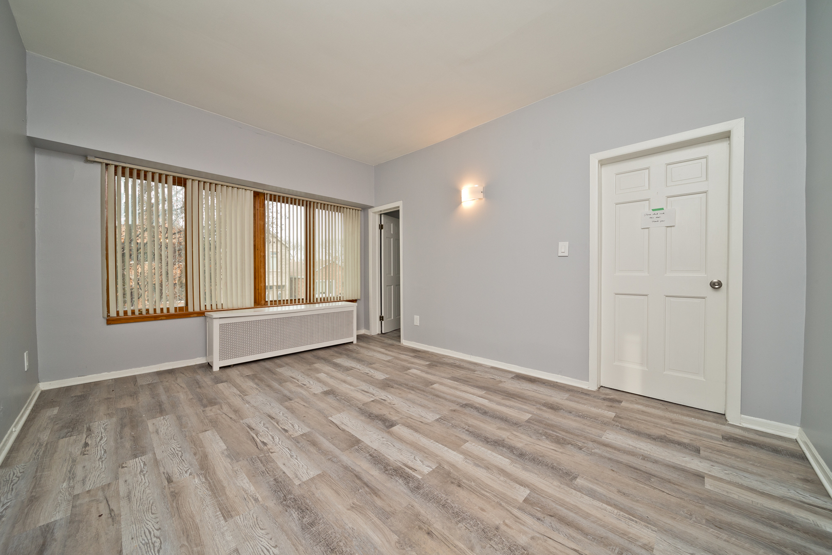 3641 South Union Avenue, Unit 2 Chicago, IL 60609 - Photo 3 of 13 a view of an empty room with wooden floor and a window
