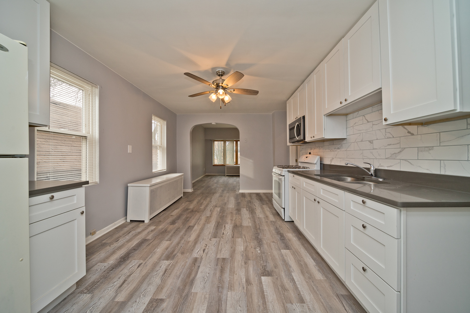 3641 South Union Avenue, Unit 2 Chicago, IL 60609 - Photo 5 of 13 a large kitchen with cabinets wooden floor and stainless steel appliances