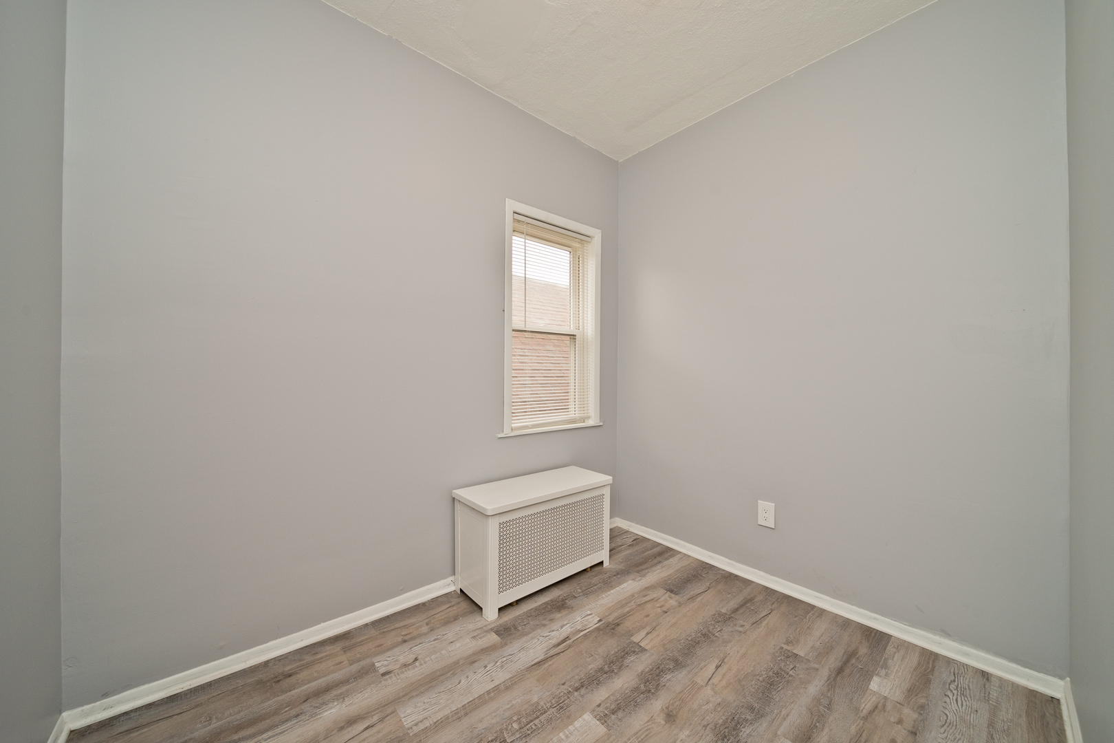 3641 South Union Avenue, Unit 2 Chicago, IL 60609 - Photo 8 of 13 a view of an empty room with wooden floor and a window