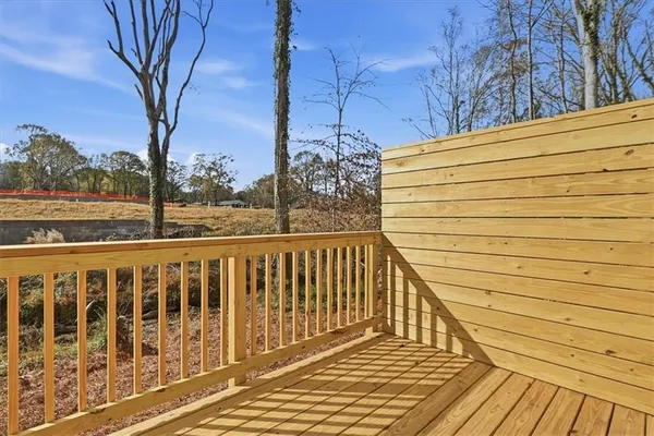a view of a balcony with wooden floor and fence