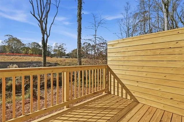 a view of a balcony with wooden floor and fence