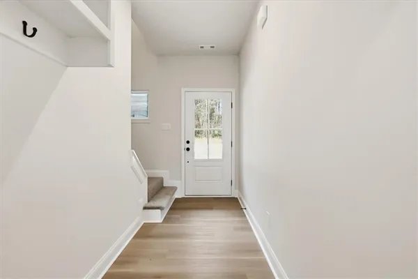 a view of a hallway with wooden floor