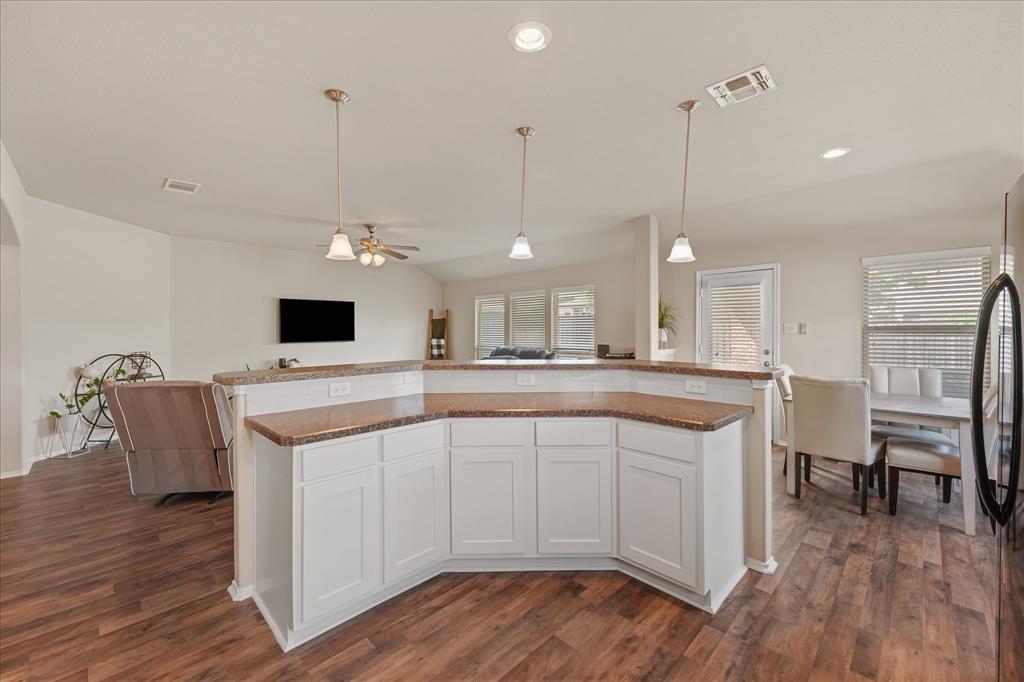 409 Harding Lane Lavon, TX 75166 - Photo 24 of 34 Spacious kitchen island featuring white cabinetry, brown countertops, and pendant lighting