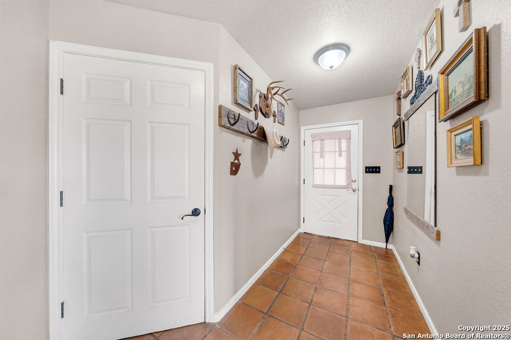16020 Farm To Market Road 463 Lytle, TX 78052 - Photo 12 of 39 a view of a hallway with a white walls