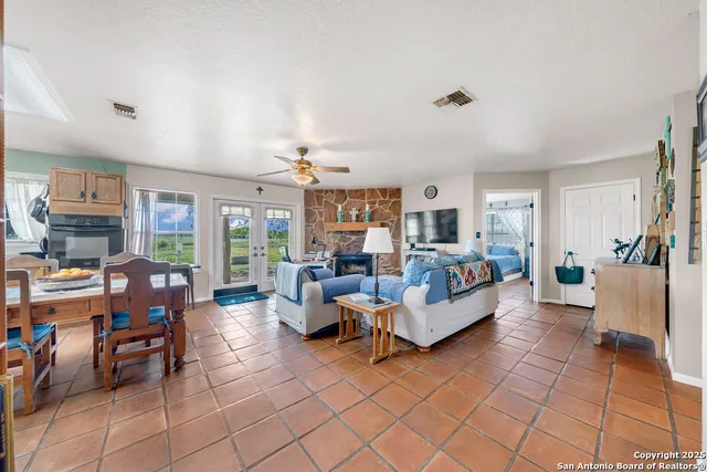 a living room with furniture a flat screen tv and kitchen view