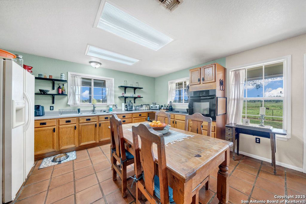 16020 Farm To Market Road 463 Lytle, TX 78052 - Photo 18 of 39 a large kitchen with lots of counter space and windows