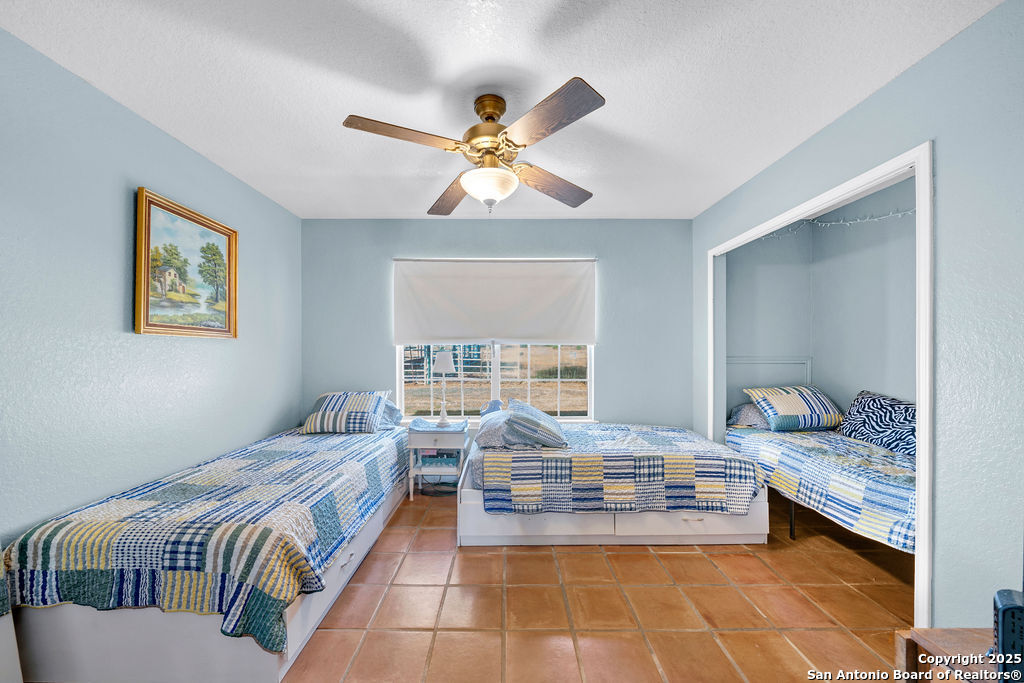 16020 Farm To Market Road 463 Lytle, TX 78052 - Photo 24 of 39 a bedroom with furniture and a large window