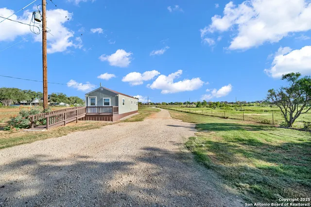 a view of a house with a yard and deck